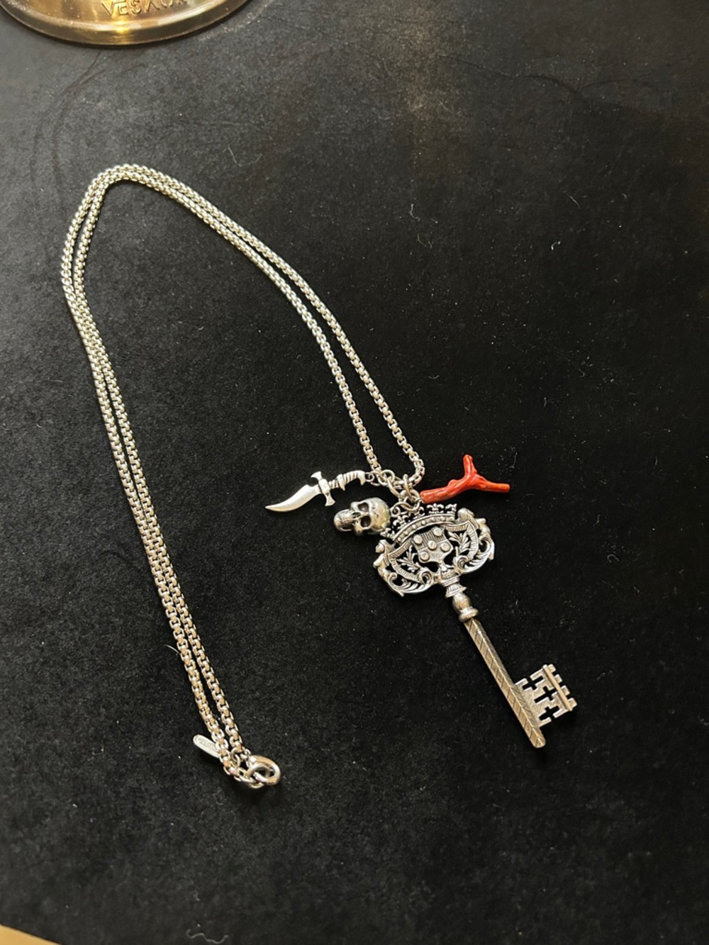 Silver Key Pendant Necklace with Red Coral, Skull, and Dagger Charms